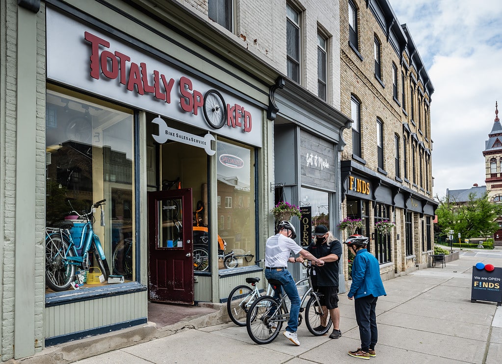 Customers trying bikes outside Totally Spoked