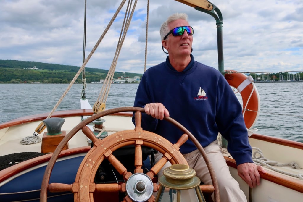 Captain of True Love at helm on Seneca Lake NY