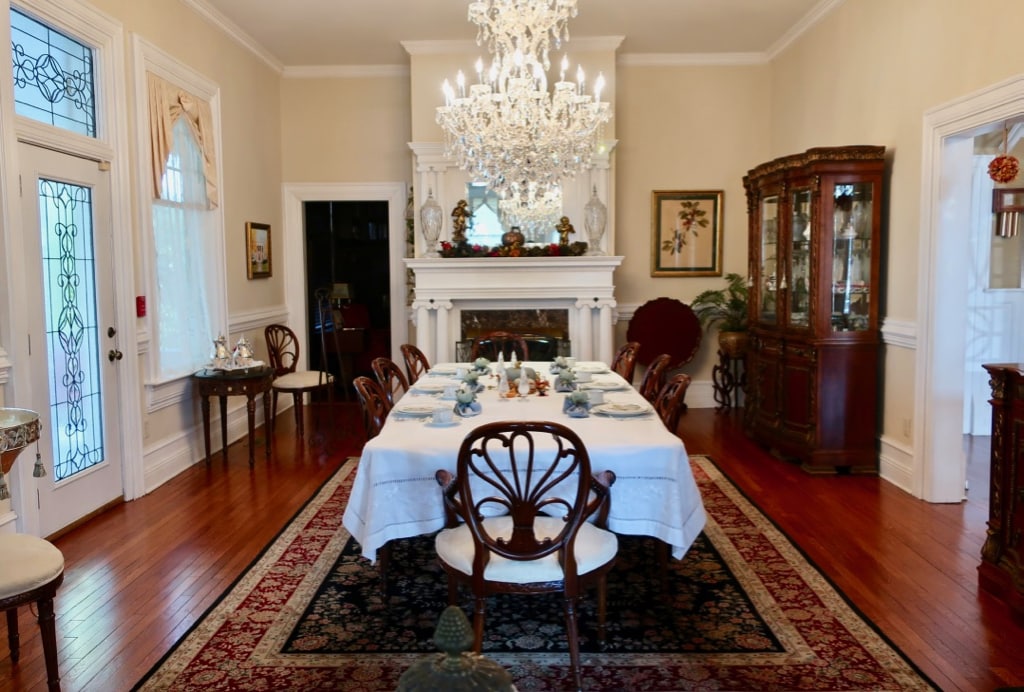 Dining table at Trinkle Mansion BnB set for breakfast in front of fireplace