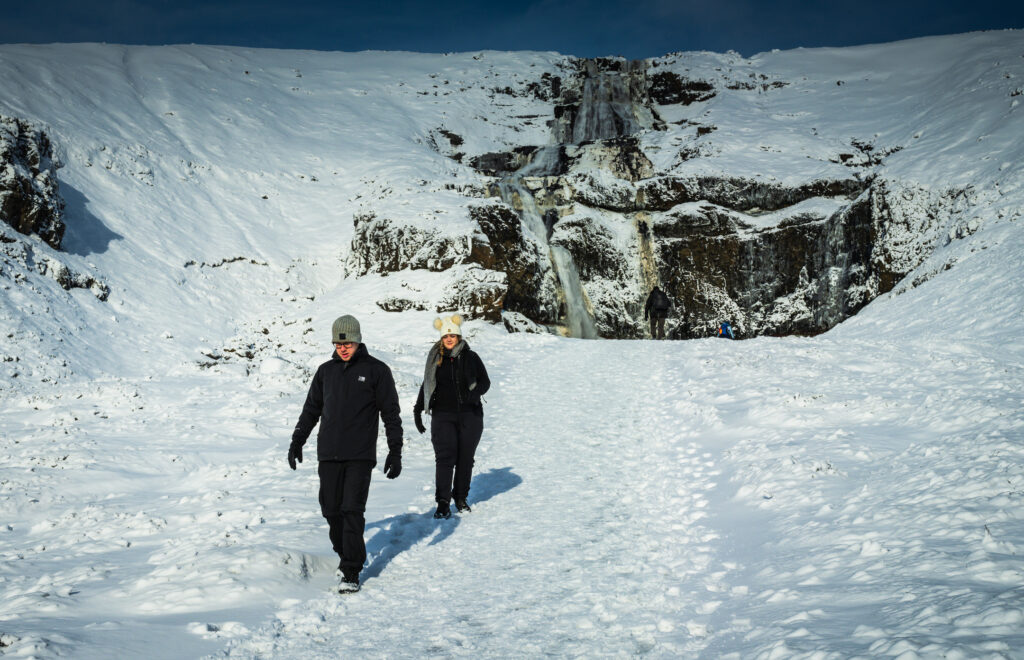 Couple walking on snow in Iceland