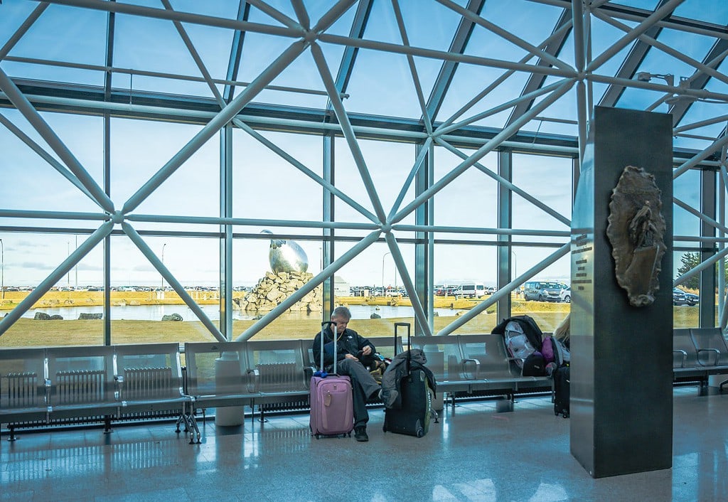 Passenger waiting at Keflavík International Airport for return from NYC to Reykjavik trip