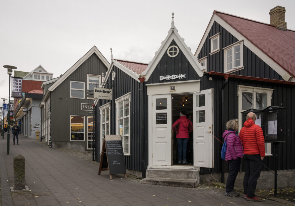 Couple looks at menu of Bakabaka Bakery on our list of Reykjavik restaurants.