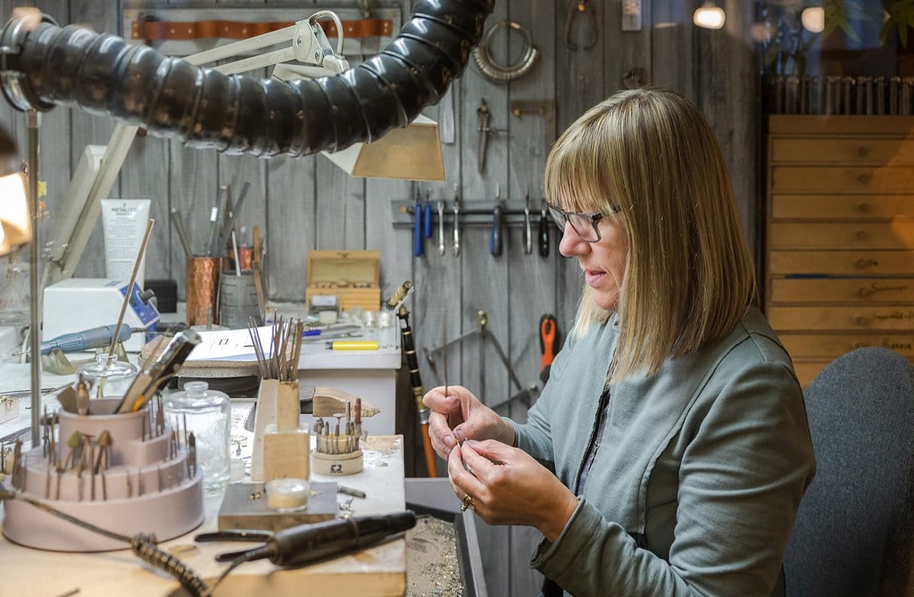 Jeweler crafting gold earrings at the Frida shop in Reykjavik.