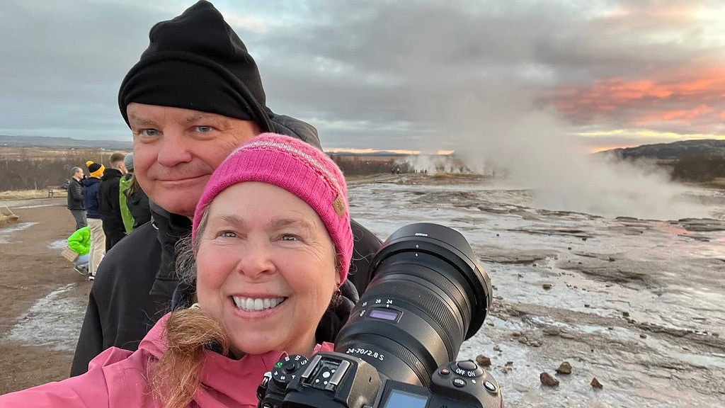 Iceland couple in front of geyser.