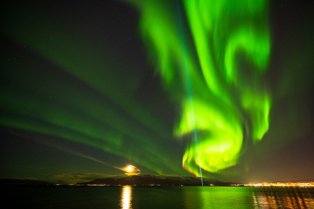 Northern lights, moon glow, and peace light over Reykjavic.