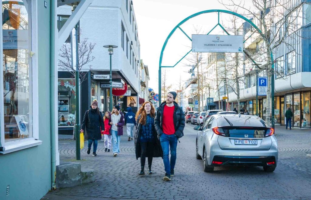 Couple strolls on Laugavegur Street in Reykjavik