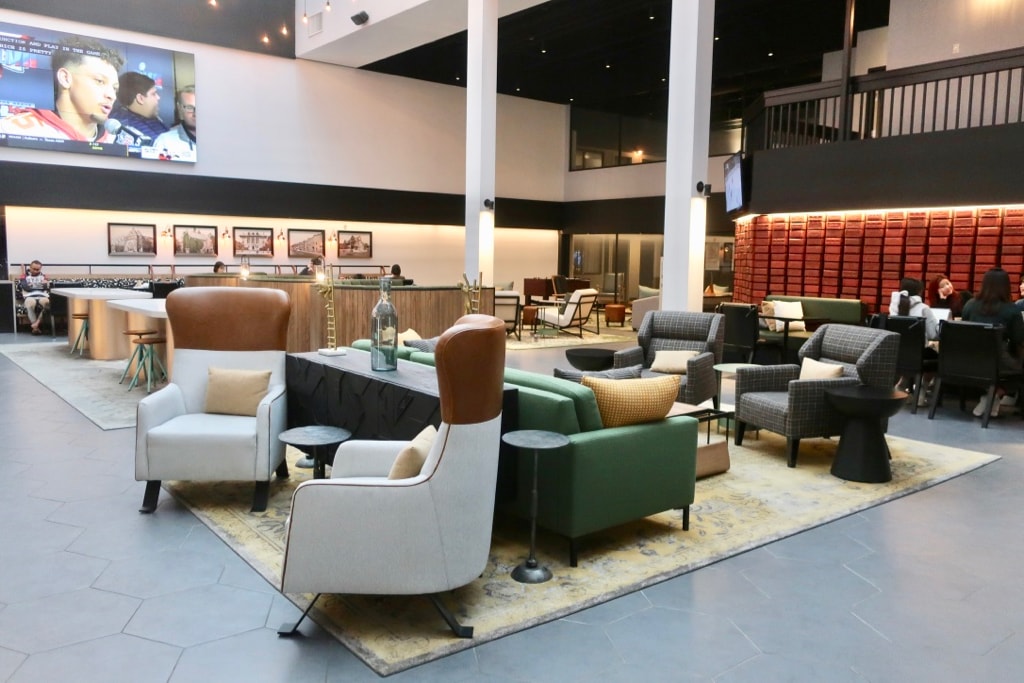 Lobby of the Arcadian Hotel Brookline MA with clusters of seating for many.