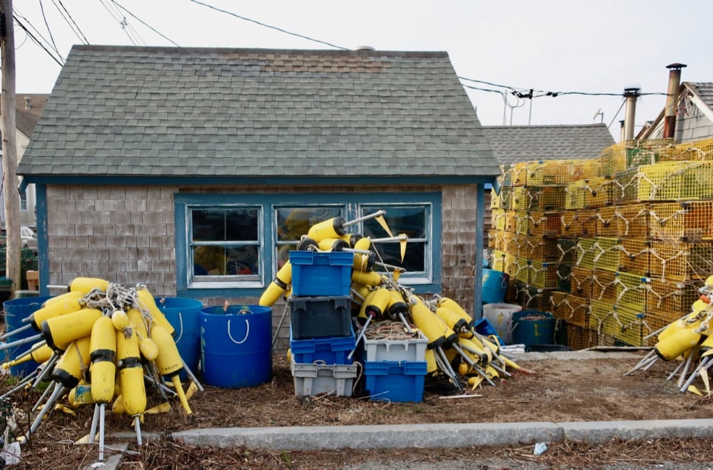 Lobster traps and buoys on land in winter Marblehead MA