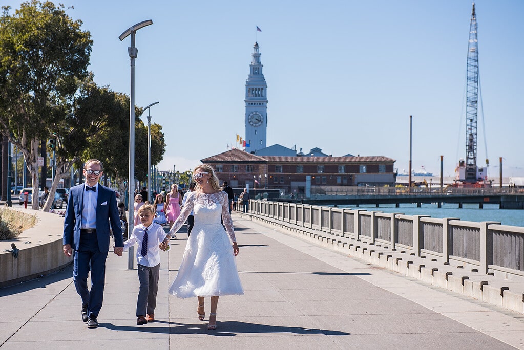 Bride and groom with child in San Francisco