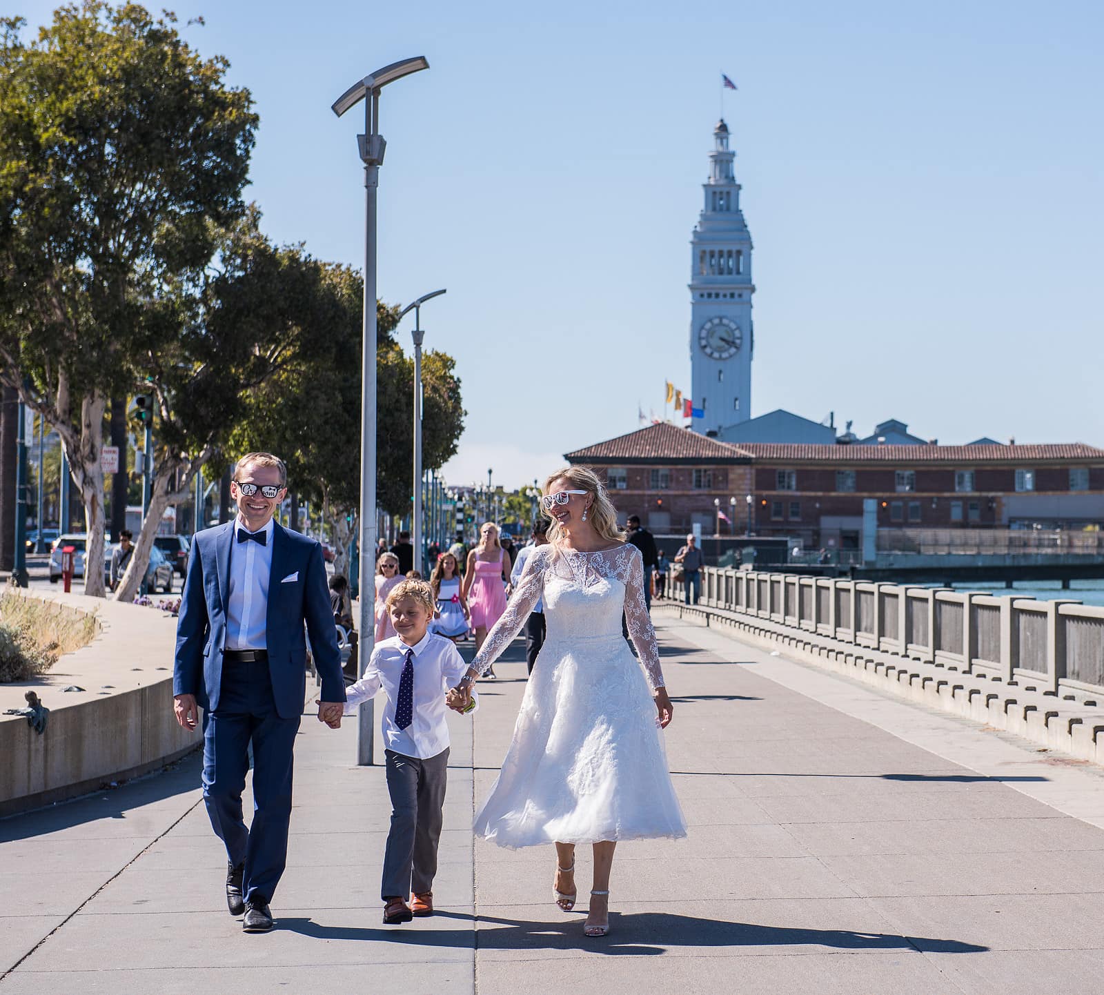 Bride and groom with child in San Francisco