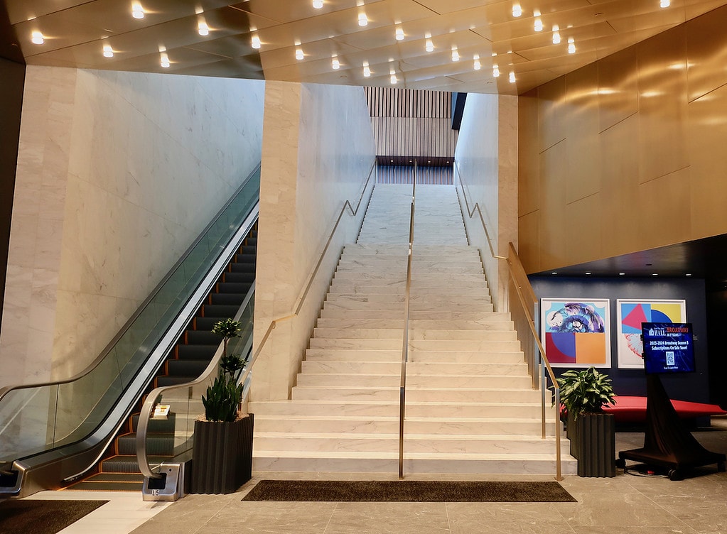 Long marble staircase ascends to the soaring atrium at Capital One Hall Tysons VA
