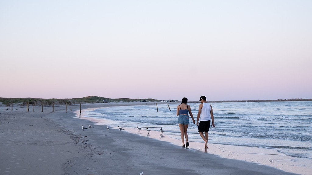 Couple walking on beach at Mustang Island State Park