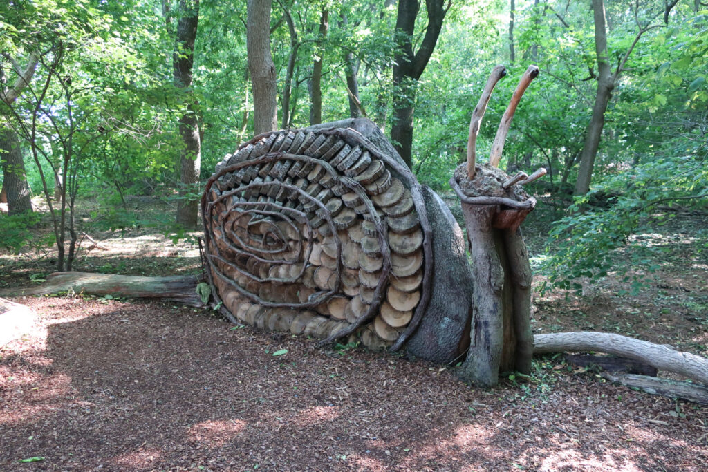Snail sculpture made of things found in nature at Delaware Botanic Garden