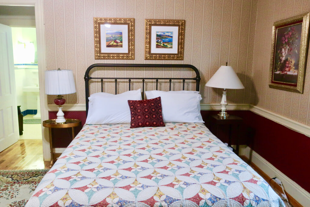 Guest room with quilted bedspread at Kane Manor Inn, Kane PA