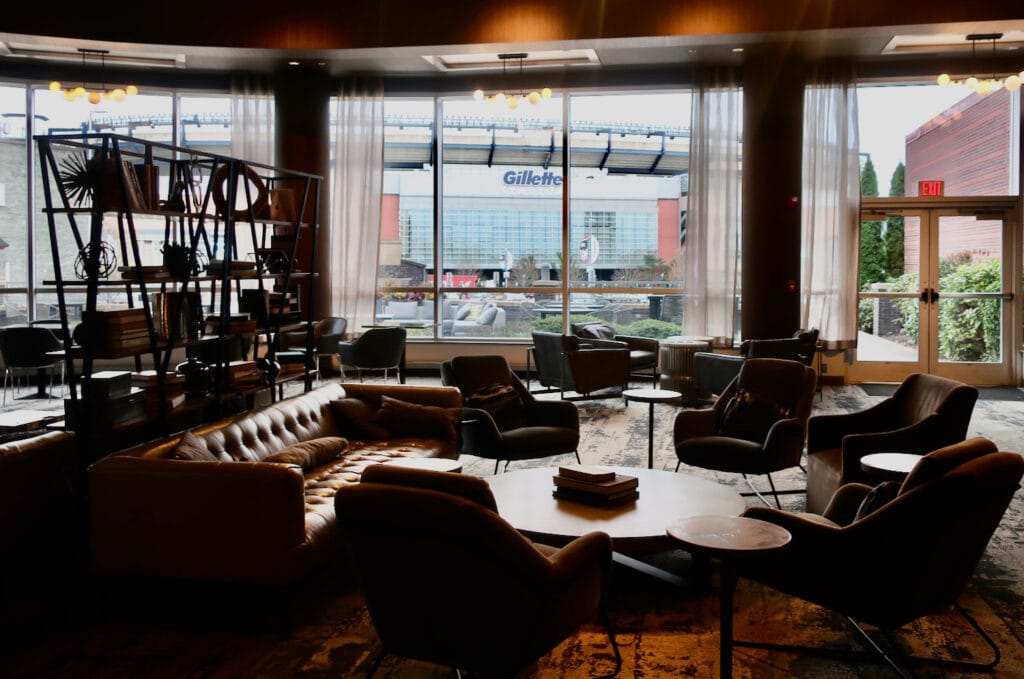 Lights of Gillette Stadium through Renaissance Hotel Patriot Place lobby windows