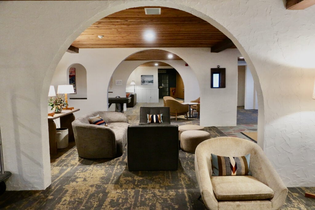Arched doorways separate the large lobby space at Sun Lodge Peru VT