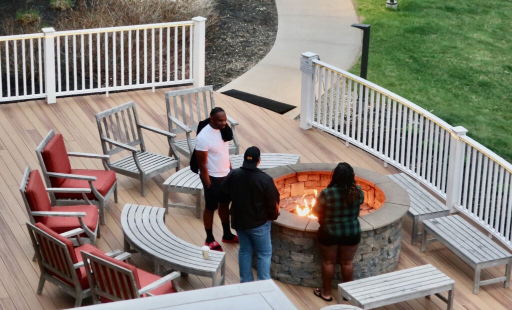 Glen House Hotel guests gather around outdoor deck fire pit.