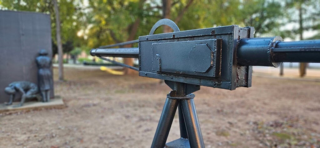 Sculpture of fire hose gun with coweriing people at Kelly Ingram Park Birmingham AL