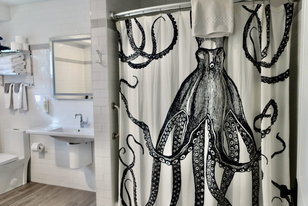 Bathroom with octopus shower curtain at Great Island Inn NH